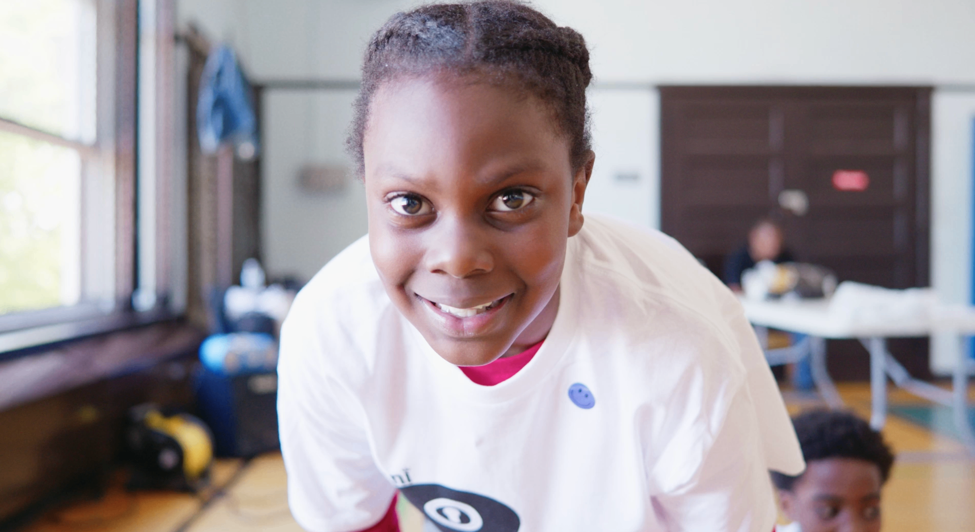 Mini Rebels participant smiling close to camera